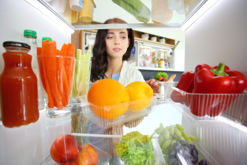 Choosing food in a fridge.