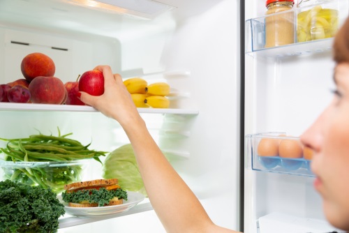 Selecting fresh food from a fridge.